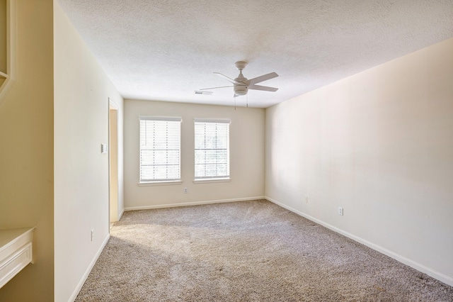 carpeted empty room featuring a textured ceiling and ceiling fan