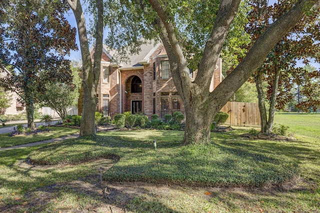 tudor-style house with a front lawn