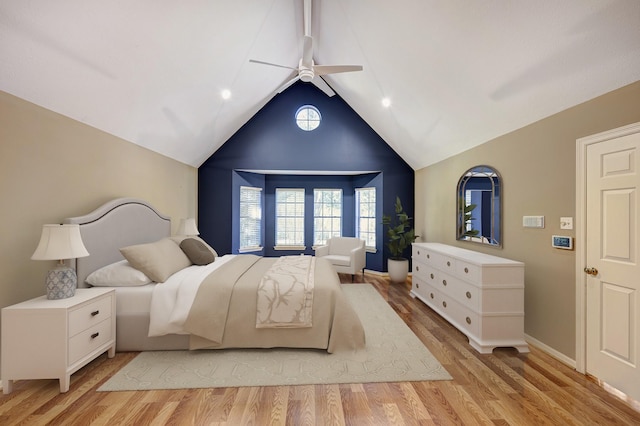 bedroom with light wood-type flooring, vaulted ceiling, and ceiling fan