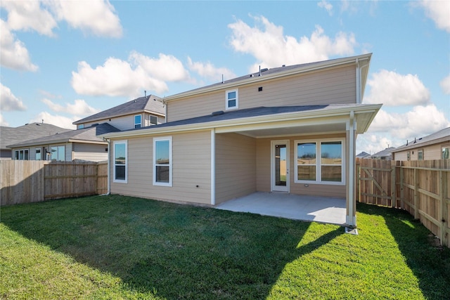 rear view of house featuring a patio area and a yard