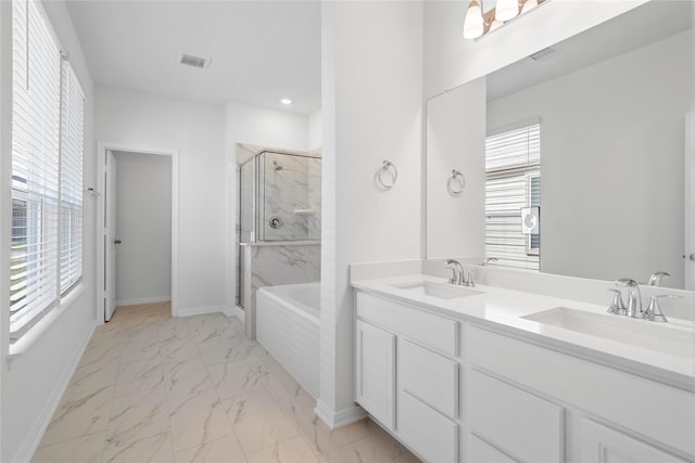 bathroom with plenty of natural light, vanity, and independent shower and bath