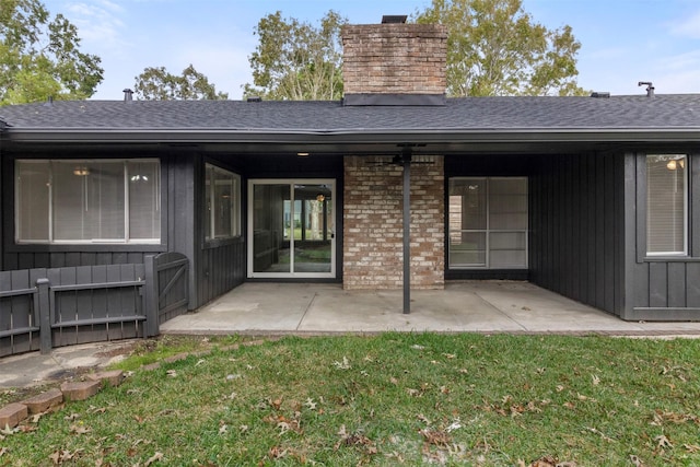 rear view of property with a yard and a patio