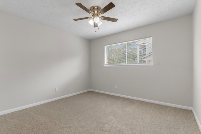 carpeted spare room with a textured ceiling and ceiling fan