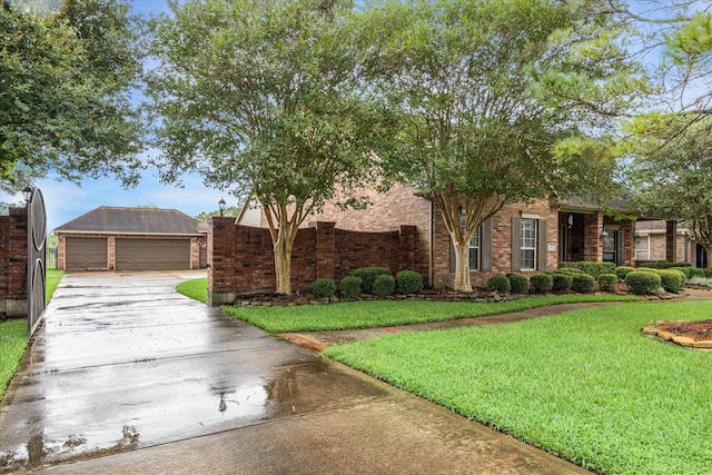 view of front of property featuring an outbuilding, a front yard, and a garage