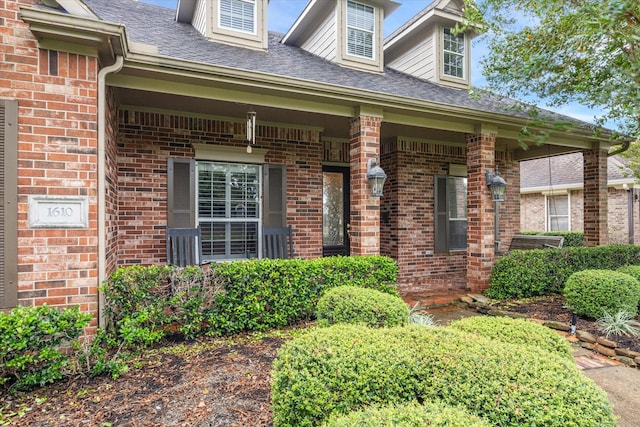 view of exterior entry with covered porch