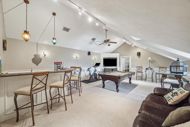 rec room with lofted ceiling with skylight, light carpet, ceiling fan, a textured ceiling, and pool table