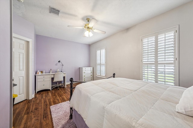 bedroom with ceiling fan and dark wood-type flooring