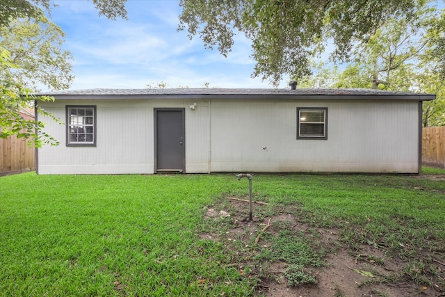 back of house with a lawn