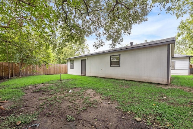 back of house with a yard