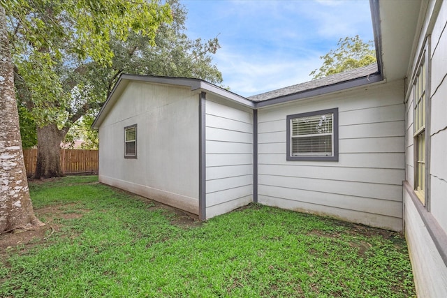 view of side of home featuring a yard