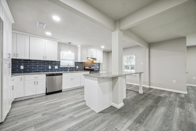 kitchen with light stone countertops, pendant lighting, white cabinets, and stainless steel appliances