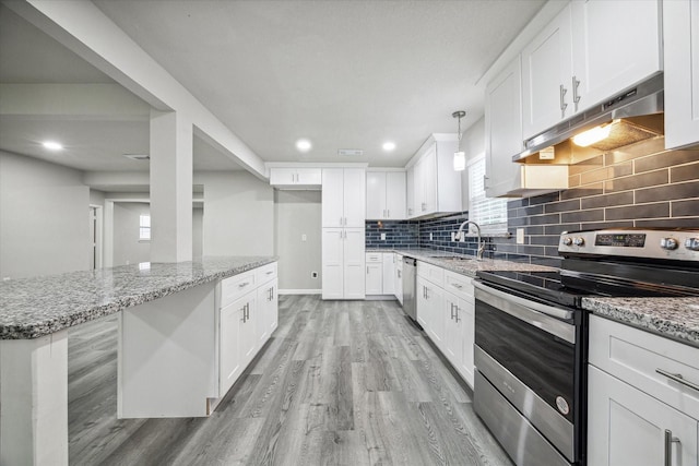 kitchen featuring light stone countertops, sink, hanging light fixtures, white cabinets, and appliances with stainless steel finishes