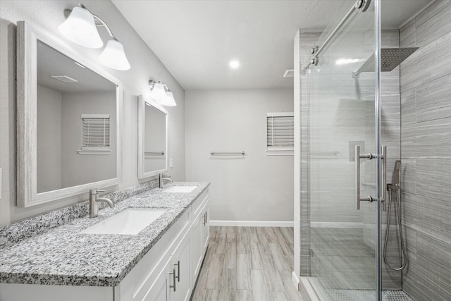 bathroom with vanity, wood-type flooring, and a shower with shower door