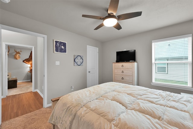 bedroom featuring ceiling fan and light colored carpet