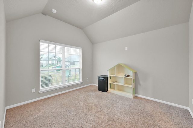 interior space with carpet flooring and lofted ceiling