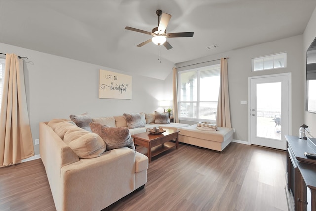 living room featuring ceiling fan, wood-type flooring, and lofted ceiling