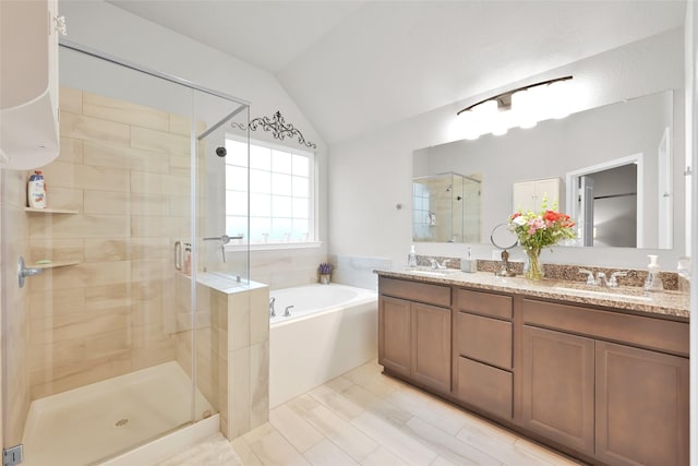 bathroom with vanity, independent shower and bath, and lofted ceiling