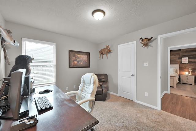 carpeted office with a textured ceiling