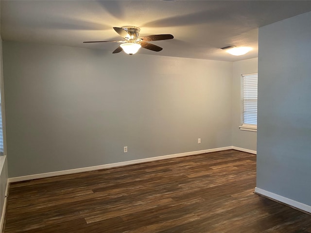 unfurnished room with dark hardwood / wood-style flooring and ceiling fan