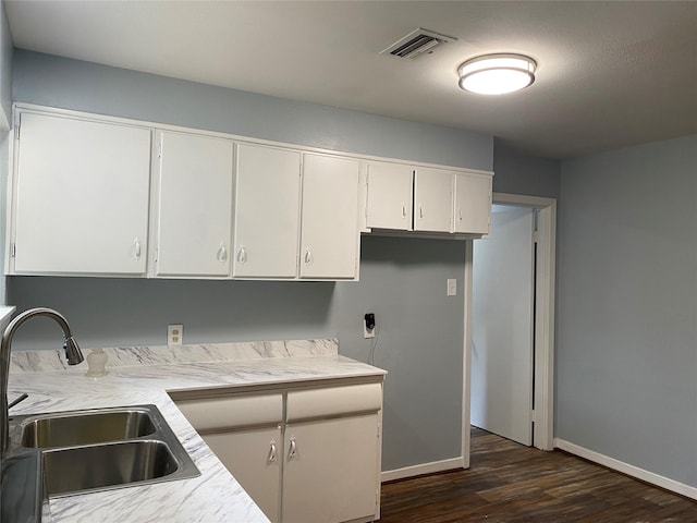 kitchen featuring white cabinets, dark hardwood / wood-style floors, and sink