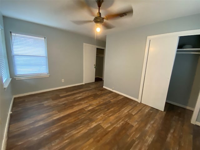 unfurnished bedroom with ceiling fan and dark hardwood / wood-style floors