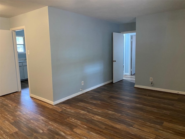 empty room featuring dark wood-type flooring