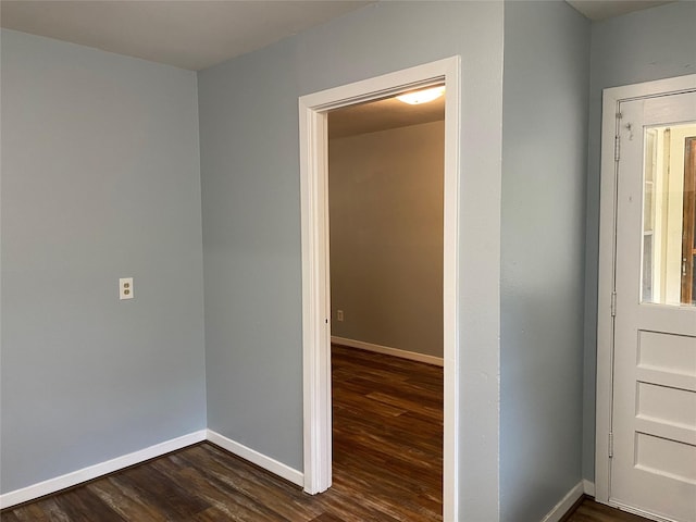 corridor with dark hardwood / wood-style flooring