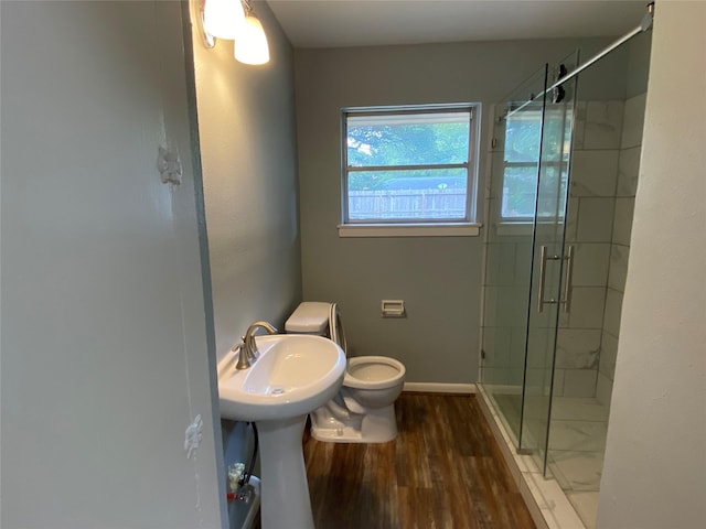 bathroom featuring walk in shower, toilet, and hardwood / wood-style flooring