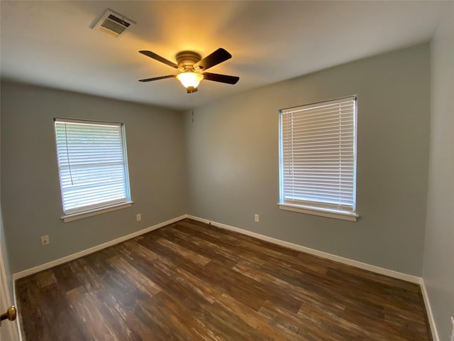 spare room featuring dark hardwood / wood-style floors and ceiling fan