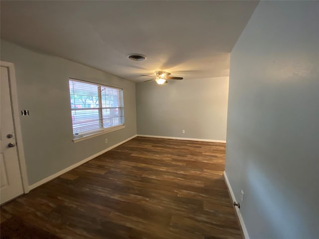 unfurnished room with ceiling fan and dark hardwood / wood-style flooring