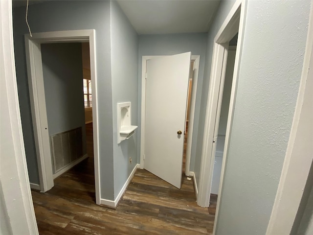 hallway featuring dark hardwood / wood-style flooring