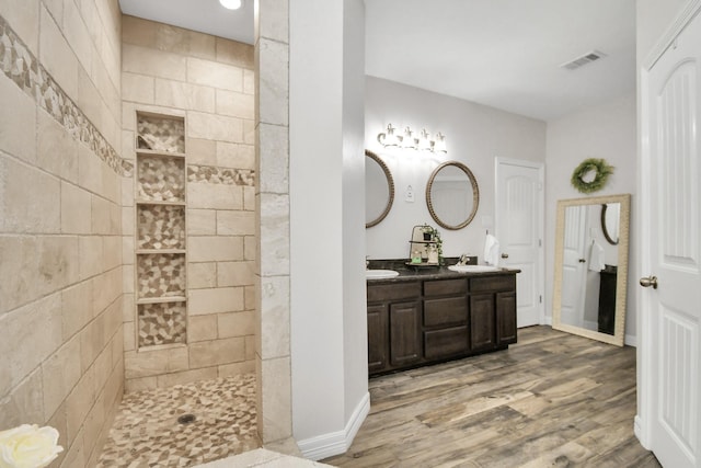 bathroom featuring walk in shower, vanity, and hardwood / wood-style flooring