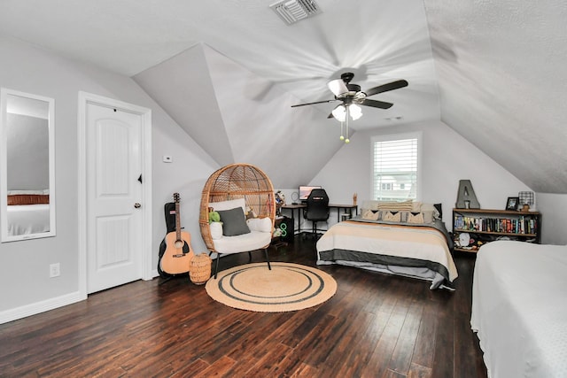 bedroom featuring dark hardwood / wood-style floors, ceiling fan, lofted ceiling, and a textured ceiling