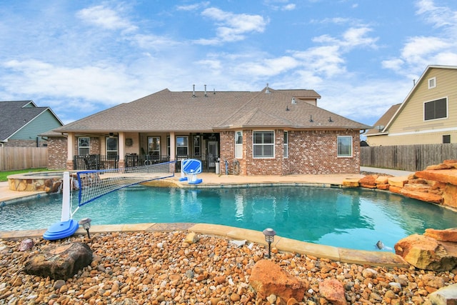 view of pool with pool water feature, a patio area, and an in ground hot tub