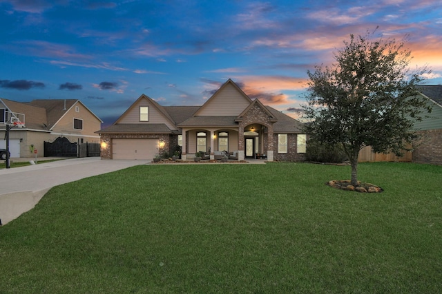 view of front of house featuring a lawn, a porch, and a garage