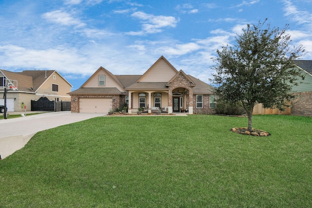 view of front of home featuring covered porch, a front yard, and a garage