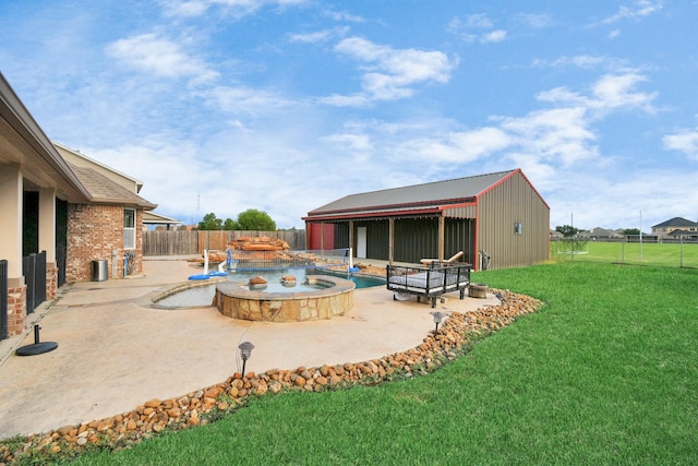 view of yard featuring pool water feature and a pool with hot tub