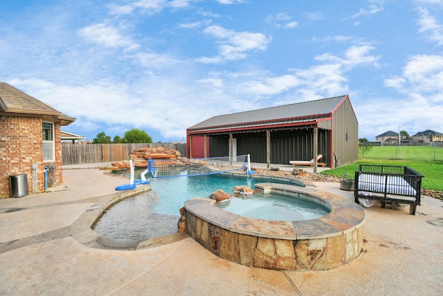 view of swimming pool featuring pool water feature and an in ground hot tub