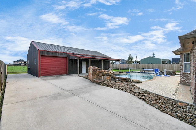 exterior space featuring a patio area, an outdoor structure, and a garage