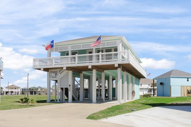 rear view of house with a carport and a lawn