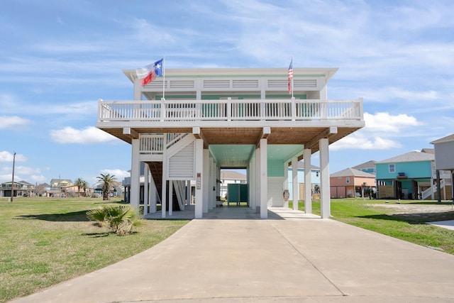 beach home with a front lawn and a carport