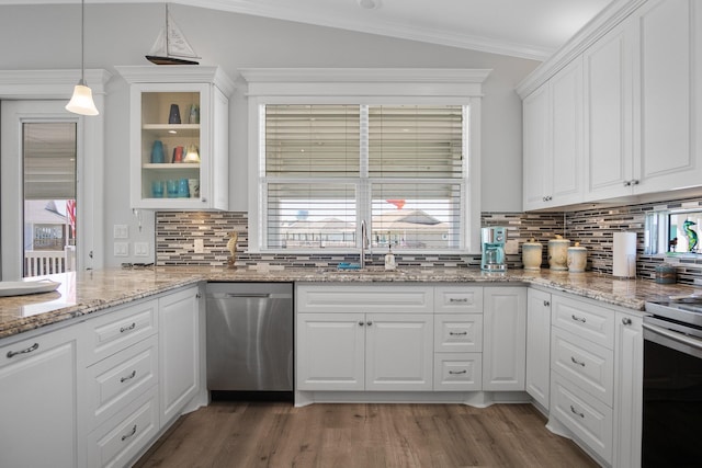 kitchen featuring decorative backsplash, white cabinetry, hanging light fixtures, and appliances with stainless steel finishes