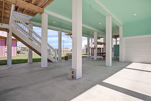 view of patio / terrace with a carport and a garage