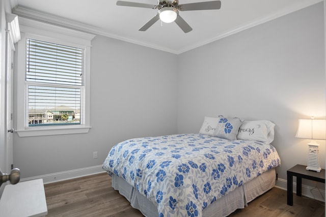 bedroom with ceiling fan, dark hardwood / wood-style flooring, and ornamental molding