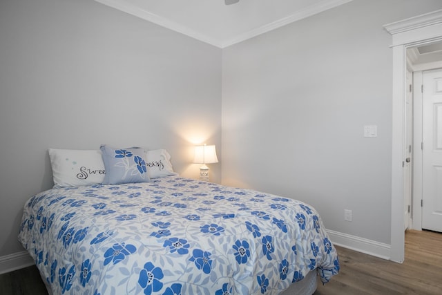 bedroom featuring dark hardwood / wood-style flooring and ornamental molding