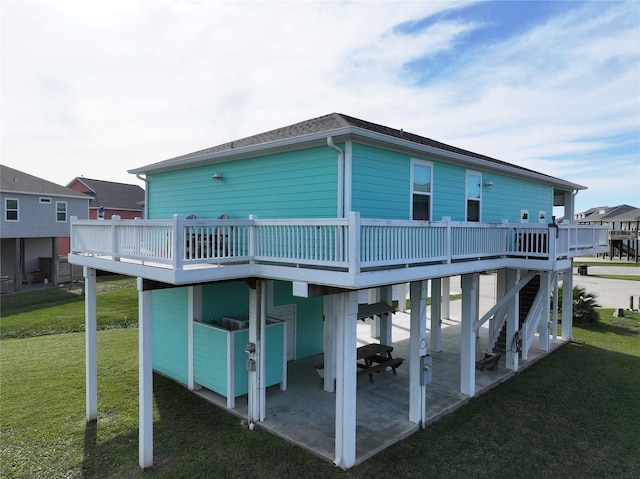 rear view of house with a patio area, a yard, and a wooden deck