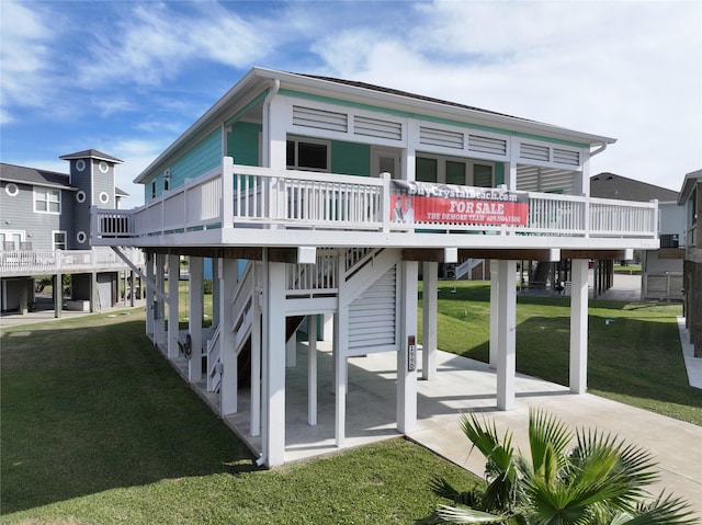 rear view of property featuring a wooden deck and a yard