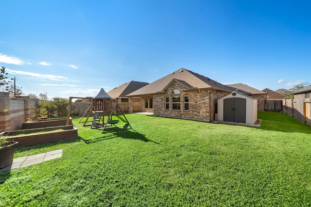 view of yard featuring a playground and a storage shed