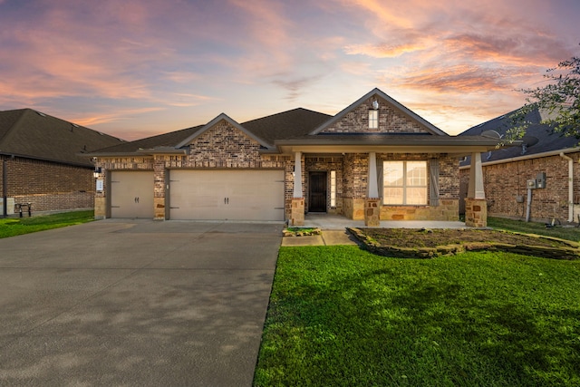 view of front of house with a yard and a garage