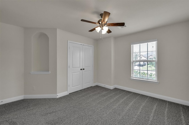 unfurnished room with carpet and ceiling fan